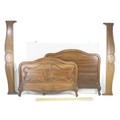 A 19th century French mahogany double bed frame, with foliate carved decoration, high head board and... 
