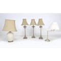 A group of five table lamps, comprising a set of three brass effect lamps with glass drops and caram... 