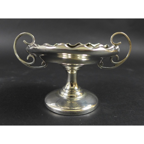 40 - A group of silver items comprising two trophies, 7.76toz, and three teething rattles, one in the for... 