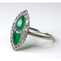 An Art Deco emerald, diamond and platinum dress ring, of scalloped marquise form, with two pear cut ... 