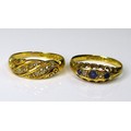 Two 18ct gold and diamond dress rings, comprising a five stone ring of two diamonds and three cornfl... 
