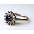 A sapphire, diamond and 18ct white gold flowerhead ring, the central sapphire of approximately 3.75m... 