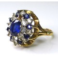 A sapphire, paste and 9ct gold dress ring, the central oval cut sapphire of approximately 5mm by 7mm... 