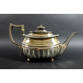 A George III silver teapot, of squat rectangular form with broad fluted lower body and gadrooned rim... 