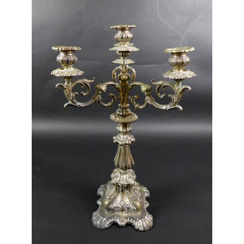 63 - A Continental white metal candelabra, late 19th century, in Rococo style with scrolling foliate deco... 