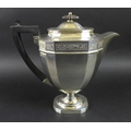 A George V silver teapot, of Neoclassical style, the faceted tapering body with an ebonised finial a... 