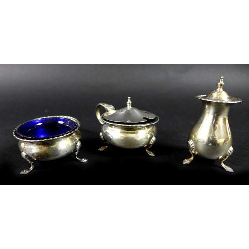 34 - A group of silver items, including a pair of silver spill vases with shaped rims, pierced foliate de... 