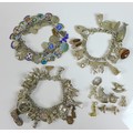 A group of silver charm bracelets, including an example decorated with silver and enamel charms of v... 