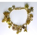 A 9ct gold charm bracelet with eighteen charms, many marked as 9ct gold, 29.3g.