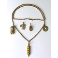A 9ct gold necklace with three charms formed as Jewish religious items, together with two loose 9ct ... 