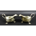 A pair of Victorian silver sauce boats, both with shaped handles, and three shell mounted legs, each... 