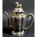 A 19th century Chinese silver wine pot, of lobed tapering form, the cover with shi shi finial, faux ... 