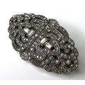 An Art Deco metamorphic brooch, white metal and set with paste, in an open latticework design, conve... 