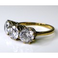 A 9ct gold and paste three stone ring, each brilliant  cut paste approximately 6mm diameter, on a 9c... 