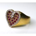 A 9ct gold, diamond and ruby valentine heart ring, formed of eighteen rubies within a recessed heart... 