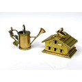 Two 18ct gold charms, one formed as a Swiss chalet, in the style of C. L. Boucher, with hinge openin... 