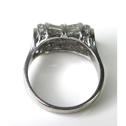 197 - An Art Deco style platinum and diamond ring of unusual tapered barrel design, set with twelve baguet... 