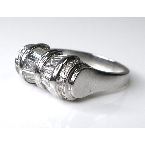 197 - An Art Deco style platinum and diamond ring of unusual tapered barrel design, set with twelve baguet... 