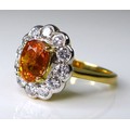 An 18ct gold, diamond and yellow sapphire dress ring, the central honey coloured oval stone of appro... 
