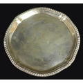 A George III small silver tray, of octagonal form with reeded rim, three scroll feet, maker's mark '... 