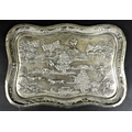 A South East Asian white metal repousse tray, late 19th / early 20th century, decorated in relief wi... 