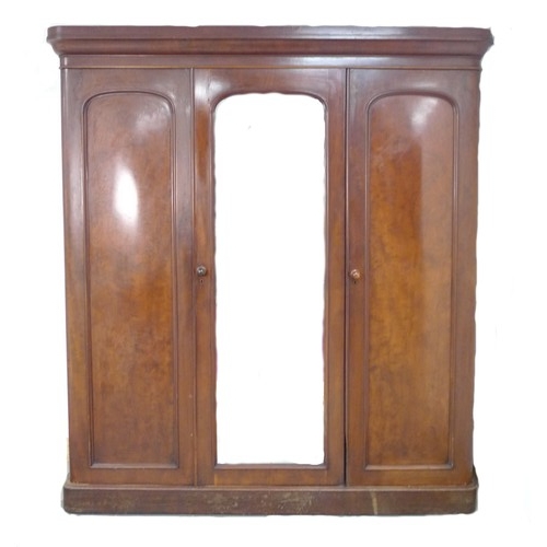 291 - A late Victorian mahogany wardrobe, of three sections, with central full length mirror door, fitted ... 