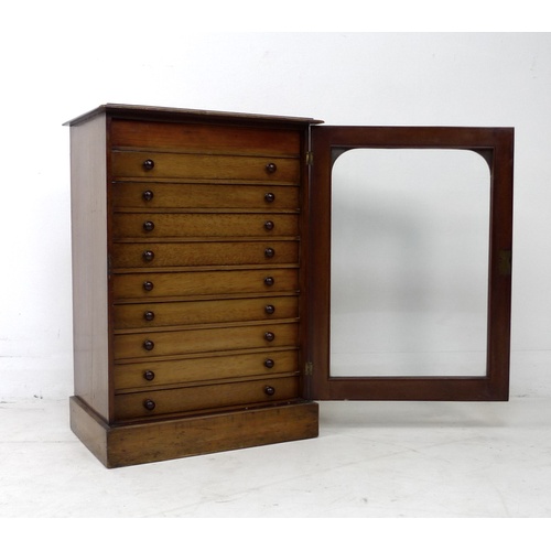 309 - A Edwardian stained pine and mahogany collectors cabinet, with a single glazed door enclosing nine s... 