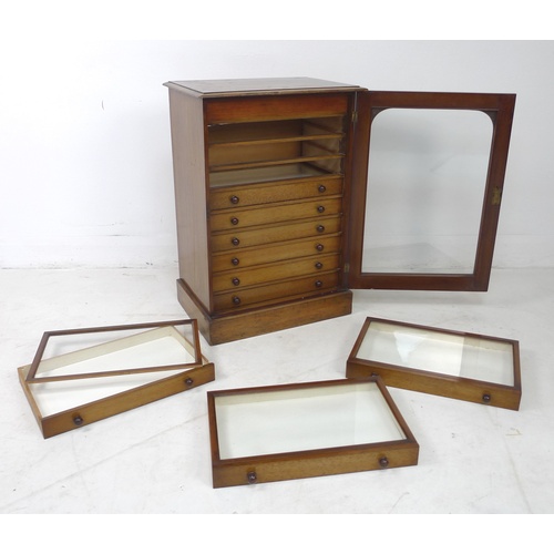 309 - A Edwardian stained pine and mahogany collectors cabinet, with a single glazed door enclosing nine s... 