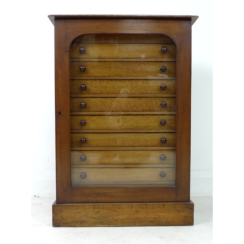 309 - A Edwardian stained pine and mahogany collectors cabinet, with a single glazed door enclosing nine s... 