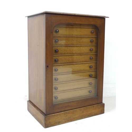 309 - A Edwardian stained pine and mahogany collectors cabinet, with a single glazed door enclosing nine s... 