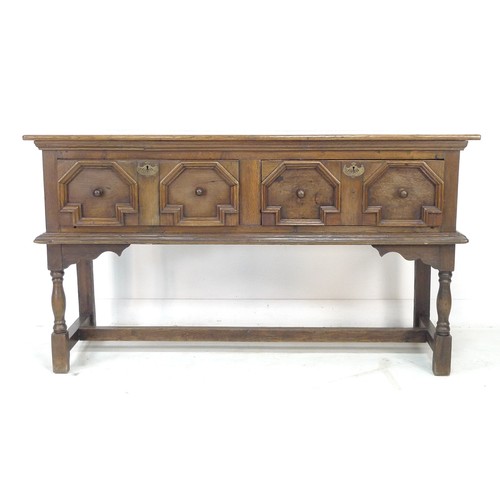 310 - An oak sideboard, two frieze drawers with Commonwealth style moulded geometric decoration, turned kn... 