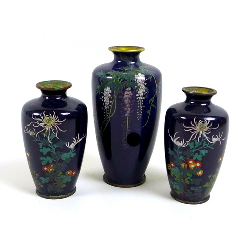 6 - A group of three Meiji period finely decorated cloisonne posy vases, comprising a pair of vases deco... 