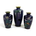 A group of three Meiji period finely decorated cloisonne posy vases, comprising a pair of vases deco... 