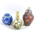 A group of Chinese ceramic vases, comprising a bottle vase, famille vert decorated with prunus bloss... 