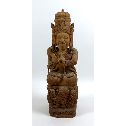 13 - An Indonesian carved wooden deity statue, mid 20th century, modelled in sitting pose with cross legs... 