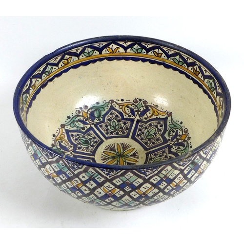 15 - A large Iznik style polychrome tin glazed earthenware pottery bowl, likely 19th century, the cream g... 