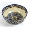 A large Iznik style polychrome tin glazed earthenware pottery bowl, likely 19th century, the cream g... 