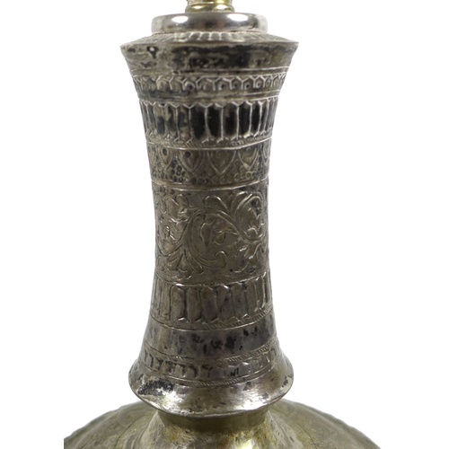16 - A white metal or brass silvered bottle vase, likely 19th century Indian the gourd form base decorate... 