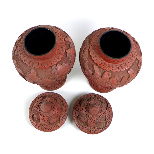 21 - A pair of Chinese covered vases, likely red resin, early to mid 20th century, made to resemble cinna... 