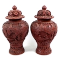 A pair of Chinese covered vases, likely red resin, early to mid 20th century, made to resemble cinna... 