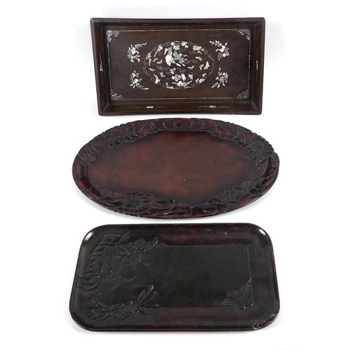 19 - A group of three Oriental hardwood trays, comprising a Chinese tray with inlaid mother of pearl deco... 