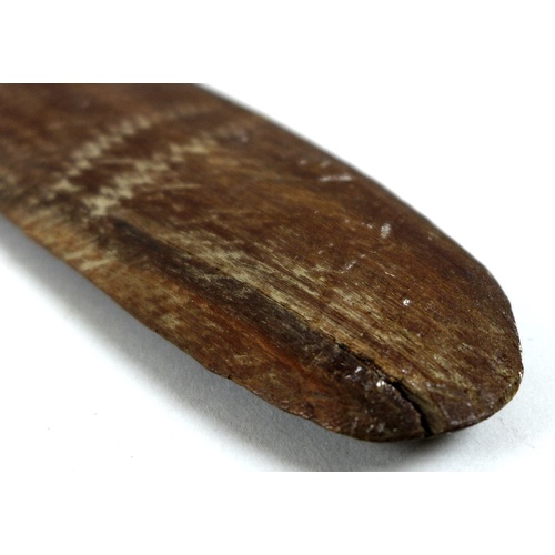 96 - An Australian Aboriginal boomerang, mid 20th century, likely stone or tooth tula carved, and with pl... 