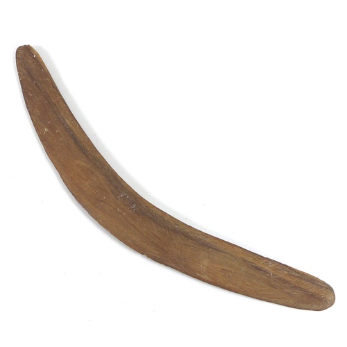 96 - An Australian Aboriginal boomerang, mid 20th century, likely stone or tooth tula carved, and with pl... 