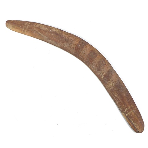 96 - An Australian Aboriginal boomerang, mid 20th century, likely stone or tooth tula carved, and with pl... 