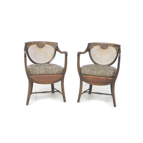 263 - A pair of Edwardian oak open armchairs, with bergere seats and backs, each 56 by 56 by 80.5cm high. ... 