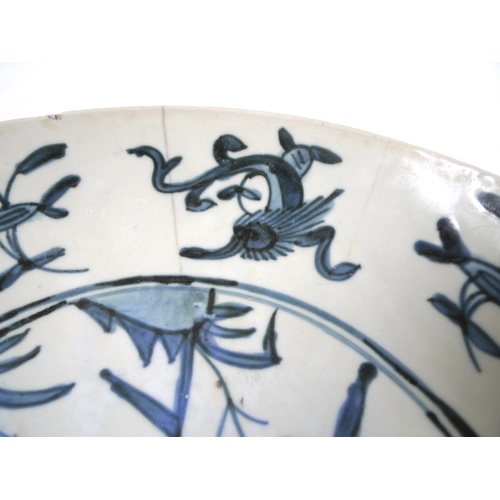 34 - A South East Asian porcelain dish, possibly Korean, decorated in blue and white to a central roundel... 