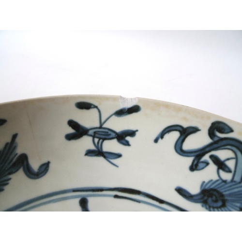 34 - A South East Asian porcelain dish, possibly Korean, decorated in blue and white to a central roundel... 