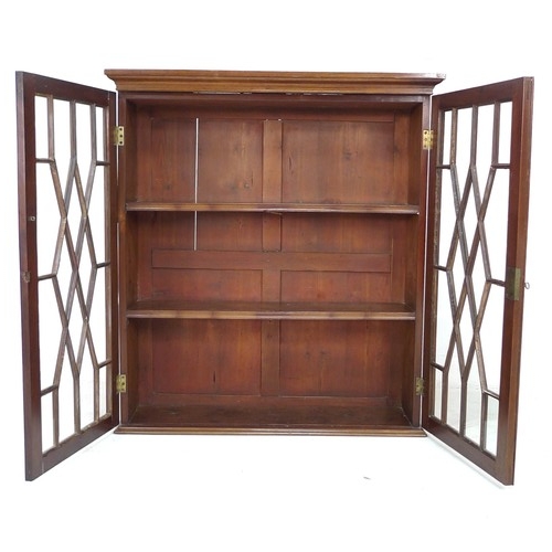 262 - A 19th century mahogany wall hanging display cupboard, twin astragal glazed doors enclosing two shel... 