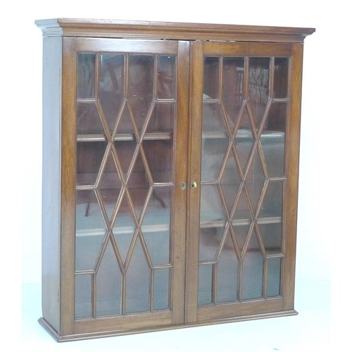 262 - A 19th century mahogany wall hanging display cupboard, twin astragal glazed doors enclosing two shel... 