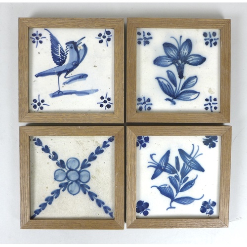 64 - A collection of sixteen tiles, comprising four 19th century Delft blue and white tiles, set into woo... 